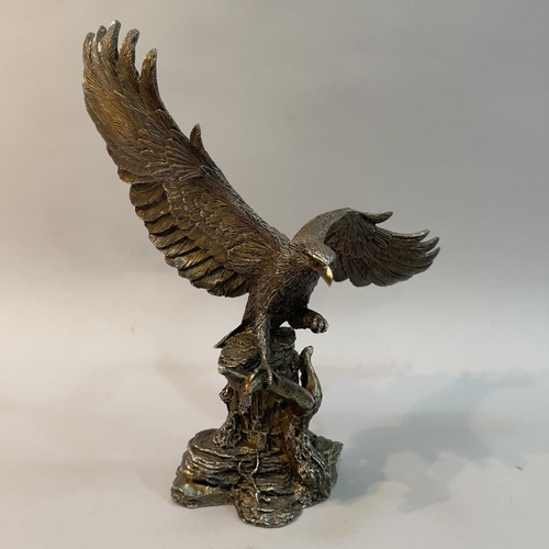 33 - A filled white metal (tests as silver) model of an Eagle by Country Artists, modelled landing on a b... 