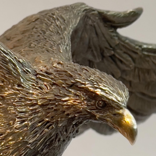 33 - A filled white metal (tests as silver) model of an Eagle by Country Artists, modelled landing on a b... 