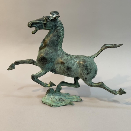 34 - A bronze Han dynasty style model of the Flying Horse of Kangxai, 16cm high, with damages