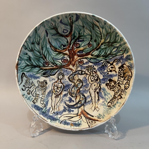 7 - A20th century earthenware dish painted with the Garden of Eden, with Adam and Eve, the apple tree an... 