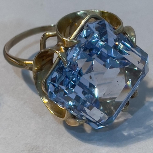 224 - A dress ring in 9ct gold claw set with a pale blue synthetic spinel, together with a Gemini Zodiac p... 