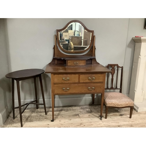 236 - An Edward VII mahogany satinwood inlaid dressing table with shield shaped mirror with drawers on tap... 