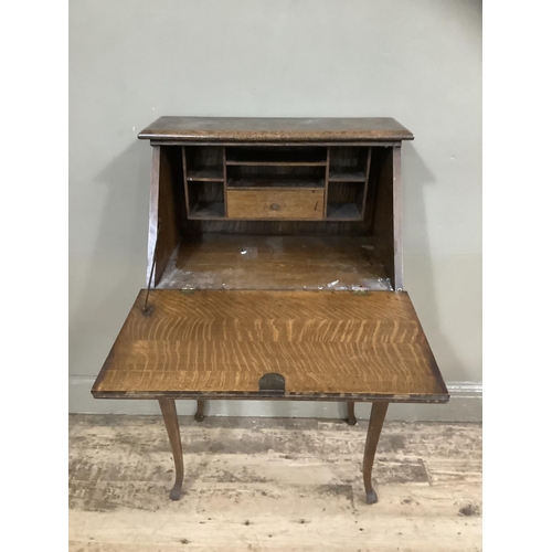 240 - An early twentieth century oak drop front bureau with fitted interior on cabriole legs