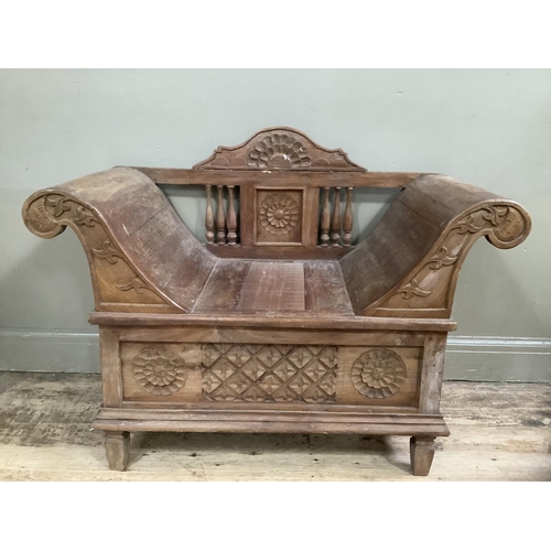 276 - A Far Eastern hall bench with scrolled arms carved back and base