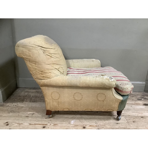 277 - A Howard and Sons style armchair on turned legs with later shepherds castors, stamped WB 3792 to bac... 