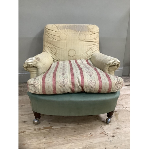 277 - A Howard and Sons style armchair on turned legs with later shepherds castors, stamped WB 3792 to bac... 