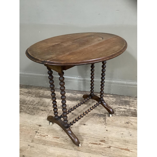 281 - A mahogany drop leaf occassional table on bobbin legs and stretcher