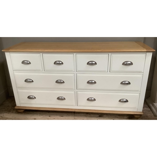 284 - A Cotswold beech bedroom suite painted off white, with a bank of four short above four long drawers ... 