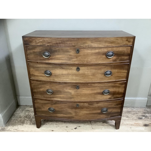 244 - A Victorian mahogany bow fronted chest of four long drawers with brass escutcheons on bracket feet, ... 