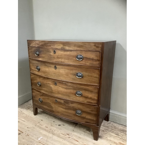 244 - A Victorian mahogany bow fronted chest of four long drawers with brass escutcheons on bracket feet, ... 