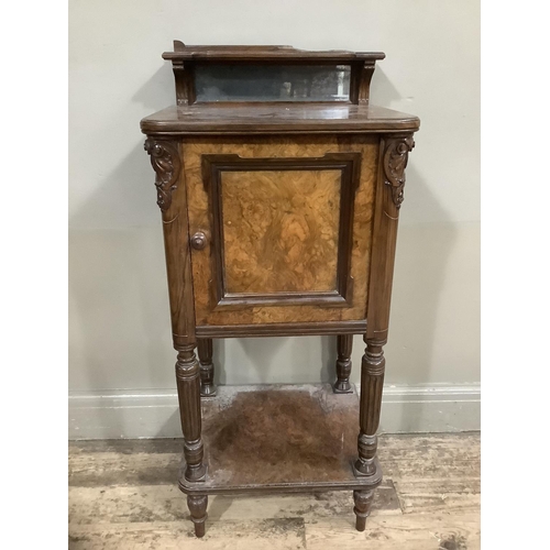 249 - A Victorian walnut  pot cupboard with mirrored back, carved sides, with column supports and under ti... 