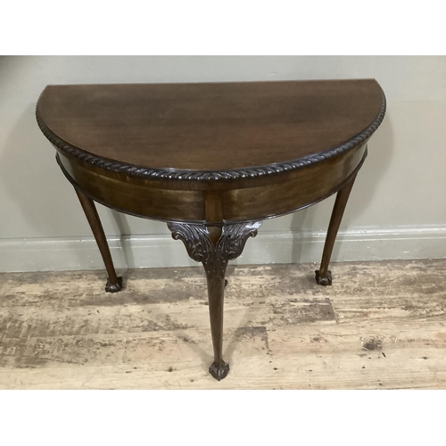 252 - An early twentieth century mahogany card table with gadroon rim having a pull out back leg with hidd... 