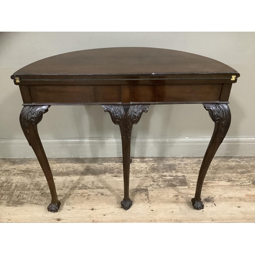 252 - An early twentieth century mahogany card table with gadroon rim having a pull out back leg with hidd... 