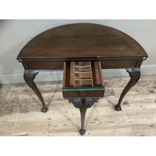 252 - An early twentieth century mahogany card table with gadroon rim having a pull out back leg with hidd... 