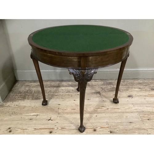 252 - An early twentieth century mahogany card table with gadroon rim having a pull out back leg with hidd... 