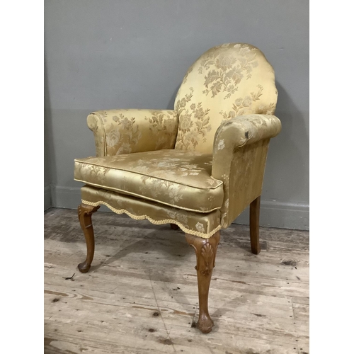 253 - A George III style walnut armchair on cabriole legs upholstered in gold fabric