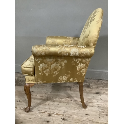 253 - A George III style walnut armchair on cabriole legs upholstered in gold fabric