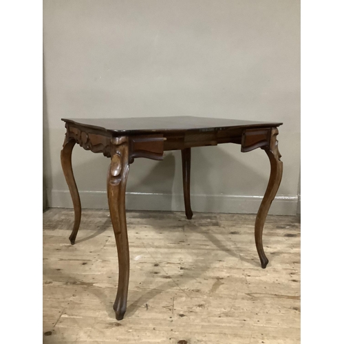 255 - A mahogany continental fold over tea table with carved apron above carved cabriole legs