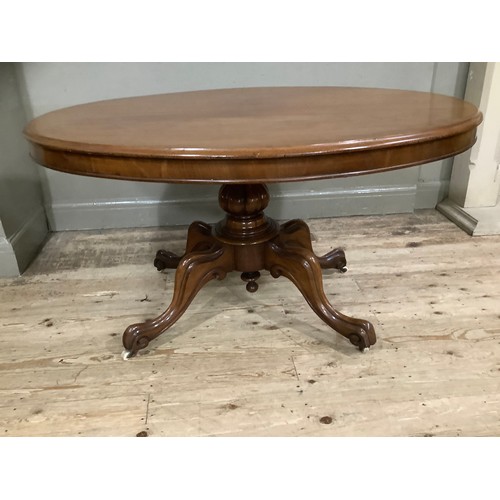 272 - A mahogany Victorian oval topped Looe table on carved baluster support on four carved legs with cast... 