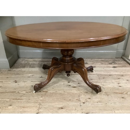 272 - A mahogany Victorian oval topped Looe table on carved baluster support on four carved legs with cast... 