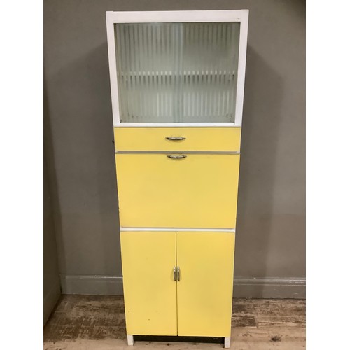 74 - A mid century yellow formica kitchen table with a glazed unit above drop down cupboard