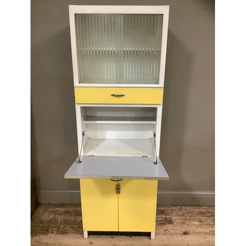 74 - A mid century yellow formica kitchen table with a glazed unit above drop down cupboard