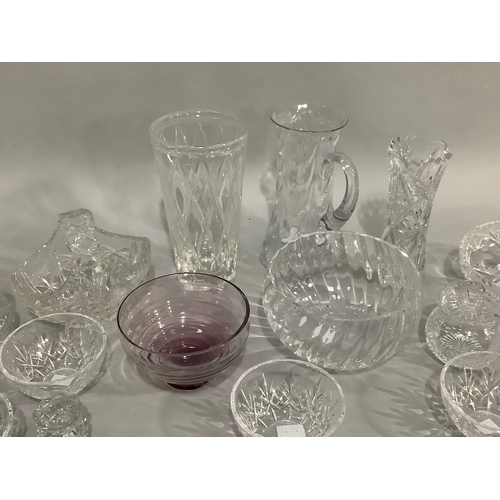 49 - A Caithness amethyst glass bowl on foot,cut glass vases, trifle bowls, and other glassware