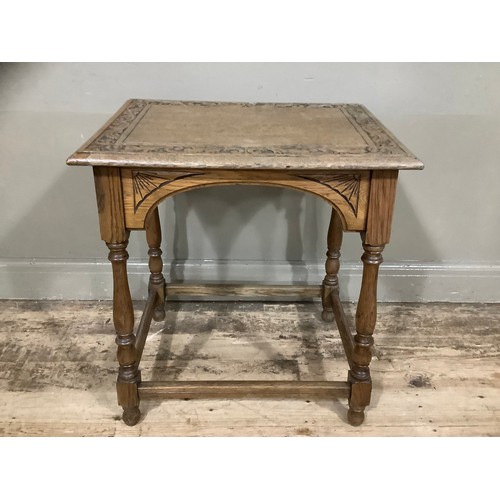 274 - An oak side table, the top carved with oak leaves on turned legs with stretcher