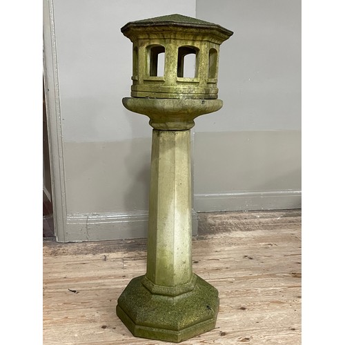 286 - A cast stone garden bird house on column, 125cm high