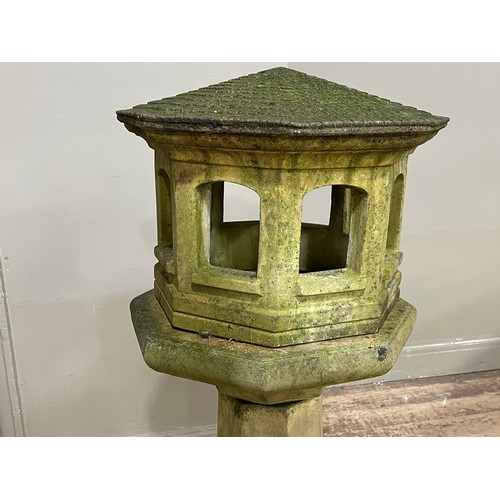 286 - A cast stone garden bird house on column, 125cm high