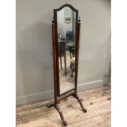 275 - An early twentieth century mahogany cheval mirror with two urn finials