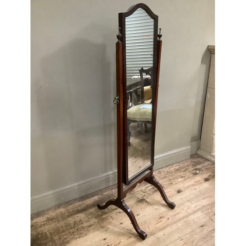 275 - An early twentieth century mahogany cheval mirror with two urn finials