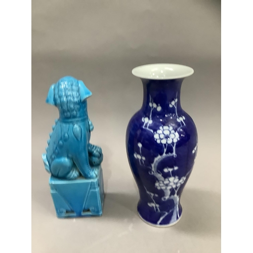 27 - A Chinese ceramic figure of a dog of fo in a turquoise glaze and a blue and white baluster vase pain... 