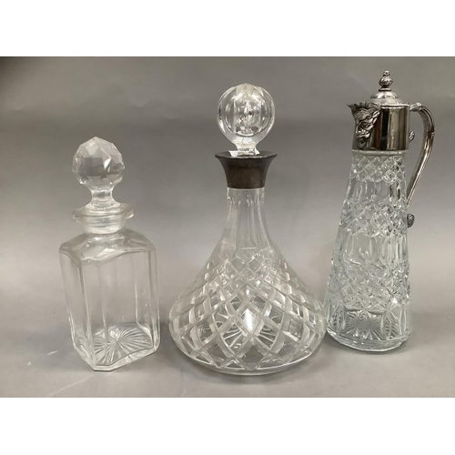 88 - A cut glass claret jug having silver plated top moulded as a face, a cut glass ships decanter with s... 