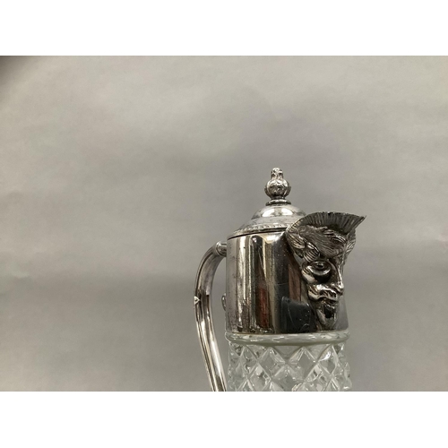 88 - A cut glass claret jug having silver plated top moulded as a face, a cut glass ships decanter with s... 