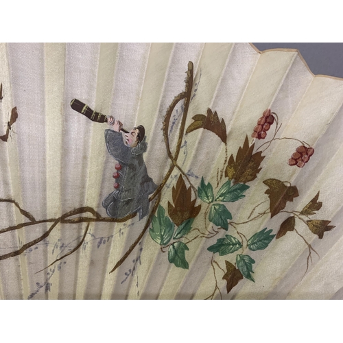 21 - Three fans from the 1890’s: a large wood fan with cream cotton leaf, painted with Pierrot kneeling o... 