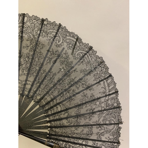 22 - Four late 19th century fans: the first quite simple, French, wood monture,
 The paper leaf inscribed... 