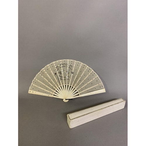 37 - An Art Nouveau fan, the monture of bone, shaped and gilded, the silk leaf painted with a lady in a s... 