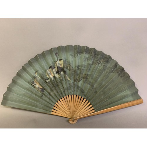 119 - Four oriental fans: a 19th century Japanese wood brisé the 18 inner sticks and two guards with round... 