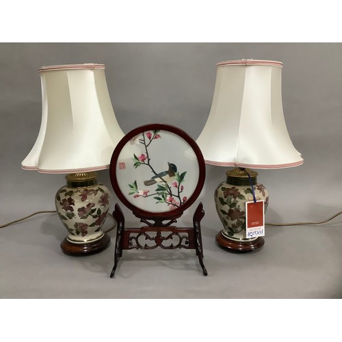 48 - A pair of modern baluster lamps enamelled with flowers and gilt on a crackle glaze ground on hardwoo... 