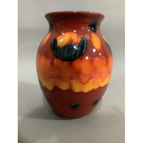 17 - A Poole pottery Volcano vase, of bulbous form with orange, red and a blue glaze, having a duck egg g... 