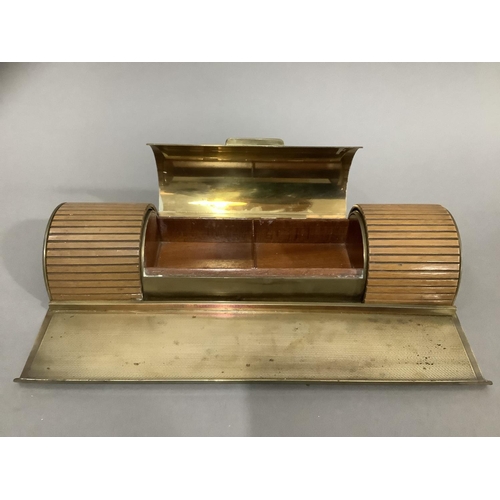 29 - An Art Deco brass desk stand, of semi-circular form, having a central teak lined compartment with hi... 