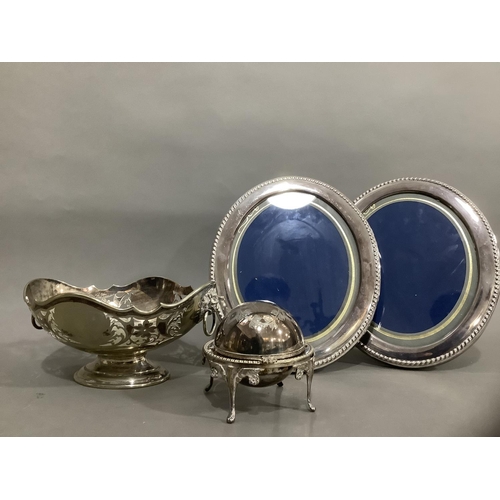 96 - A silver plated pierced basket with lion mask handles on foot, a silver plated domed butter dish on ... 