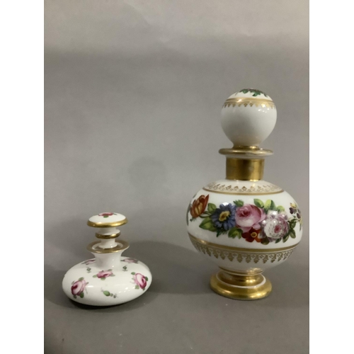 9 - A continental scent bottle with bulbous body and globe stopper, hand painted with sprays of flower a... 