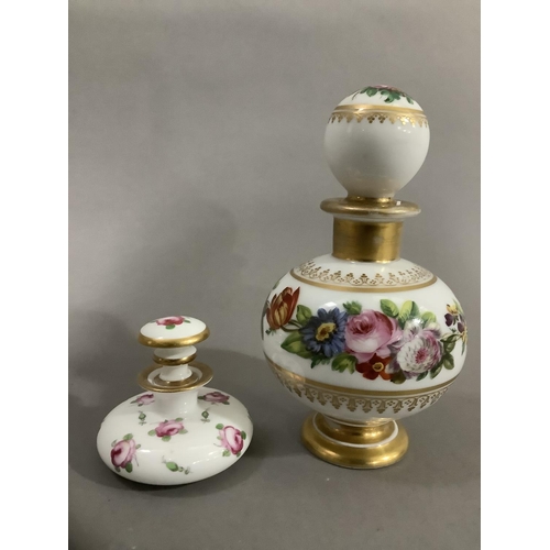 9 - A continental scent bottle with bulbous body and globe stopper, hand painted with sprays of flower a... 