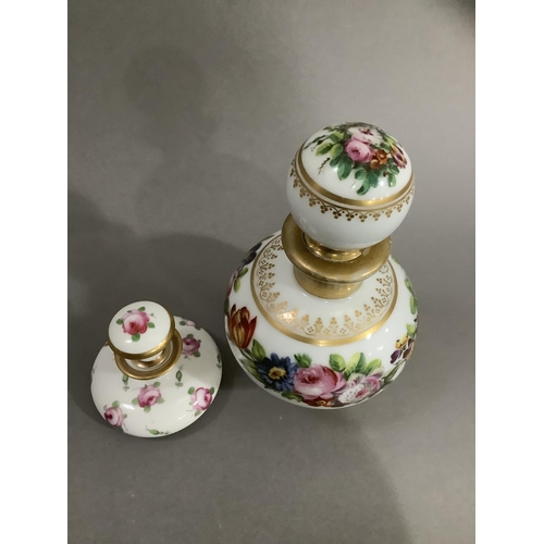 9 - A continental scent bottle with bulbous body and globe stopper, hand painted with sprays of flower a... 