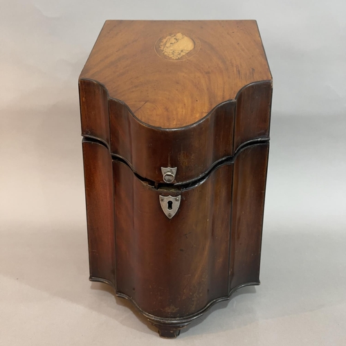 145 - A George III mahogany serpentine fronted knife box, the lid inlaid with a shell, later brass lion ma... 