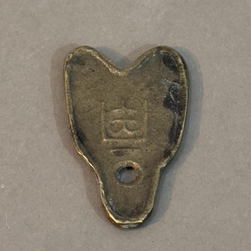 195 - A 20th Century Brass Sanctuary Bell string holder and a Chinese spade coin