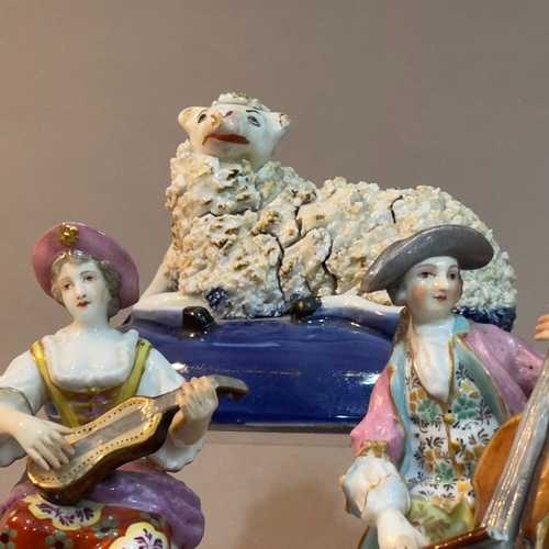 70 - A Staffordshire figure of a recumbent sheep on blue base, a pair of continental china figures of a m... 