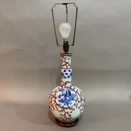 152 - A Chinese red, blue and gourd vase converted to a lamp on carved hardwood base, the body having cart... 